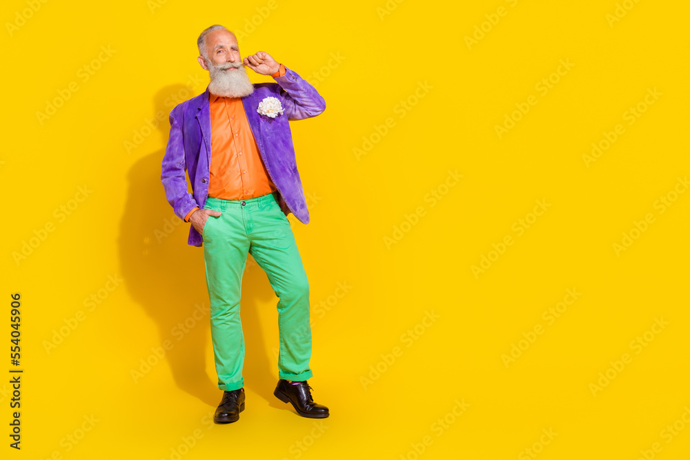 Fototapeta premium Full length photo of nice grandparent touch mustache bachelorette party dressed stylish colorful look isolated on yellow color background
