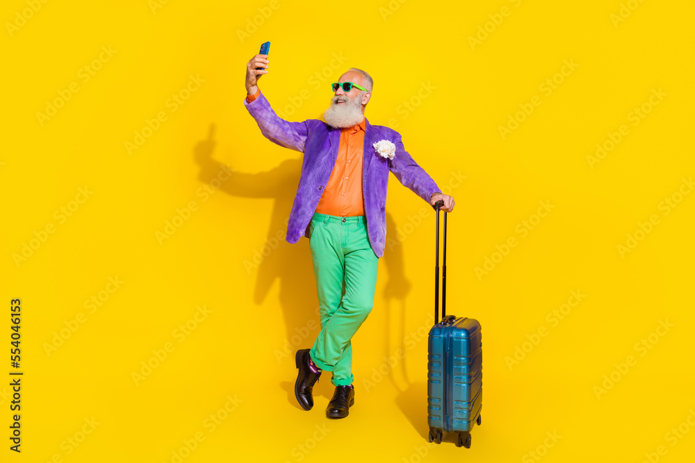 Full size photo of classy elegant person hold telephone make selfie isolated on yellow color background Full size photo of classy elegant person hold telephone make selfie isolated on yellow color background