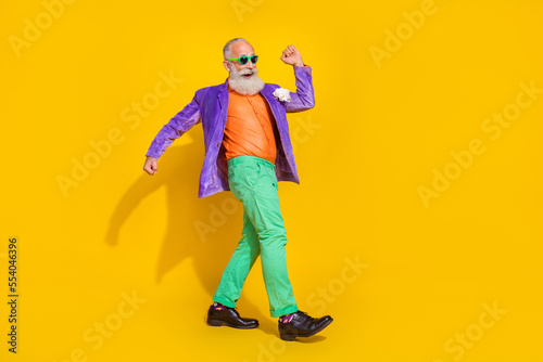 Full body photo of attractive grandparent have fun step dancing boogie woogie wear trendy colorful look isolated on yellow color background
