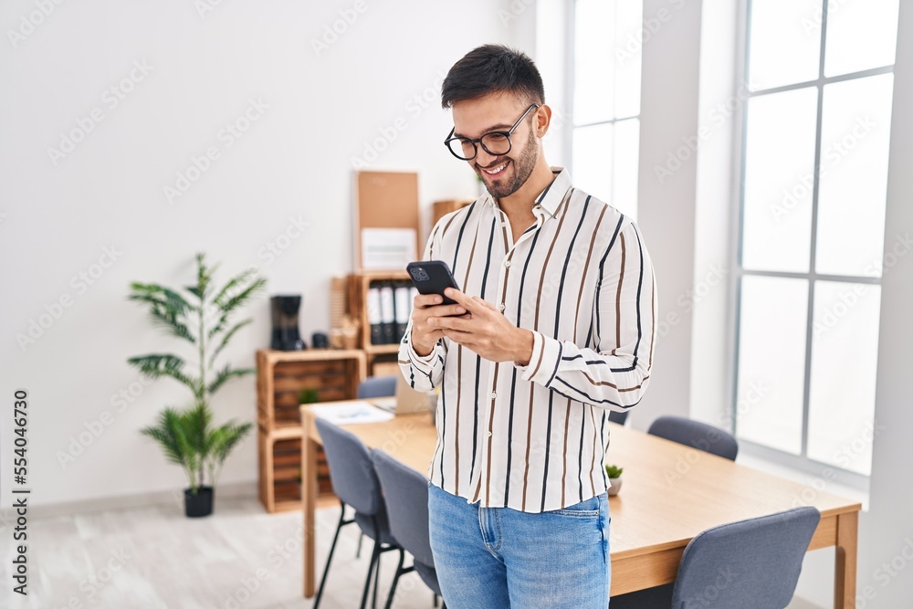 Young hispanic man business worker smiling confident using smartphone at office Young hispanic man business worker smiling confident using smartphone at office