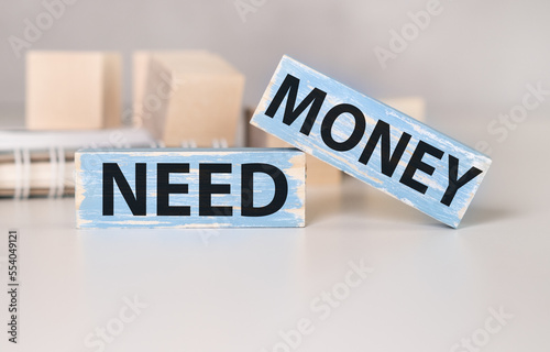 money and need money question on wooden blocks