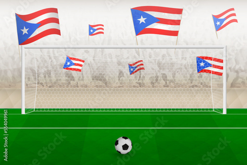 Puerto Rico football team fans with flags of Puerto Rico cheering on stadium, penalty kick concept in a soccer match.
