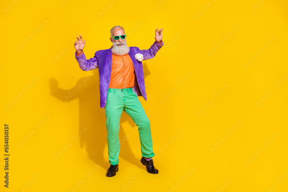 Full length photo of nice grandparent dancing have fun theme party dressed stylish colorful garment isolated on yellow color background Full length photo of nice grandparent dancing have fun theme party dressed stylish colorful garment isolated on yellow color background