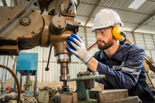 Team of engineers practicing maintenance Taking care and practicing maintenance of old machines in the factory so that they can be used continuously.