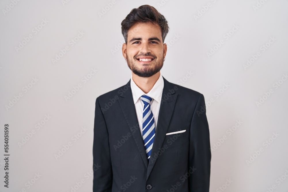 Young hispanic man with tattoos wearing business suit and tie with a happy and cool smile on face. lucky person. Young hispanic man with tattoos wearing business suit and tie with a happy and cool smile on face. lucky person.