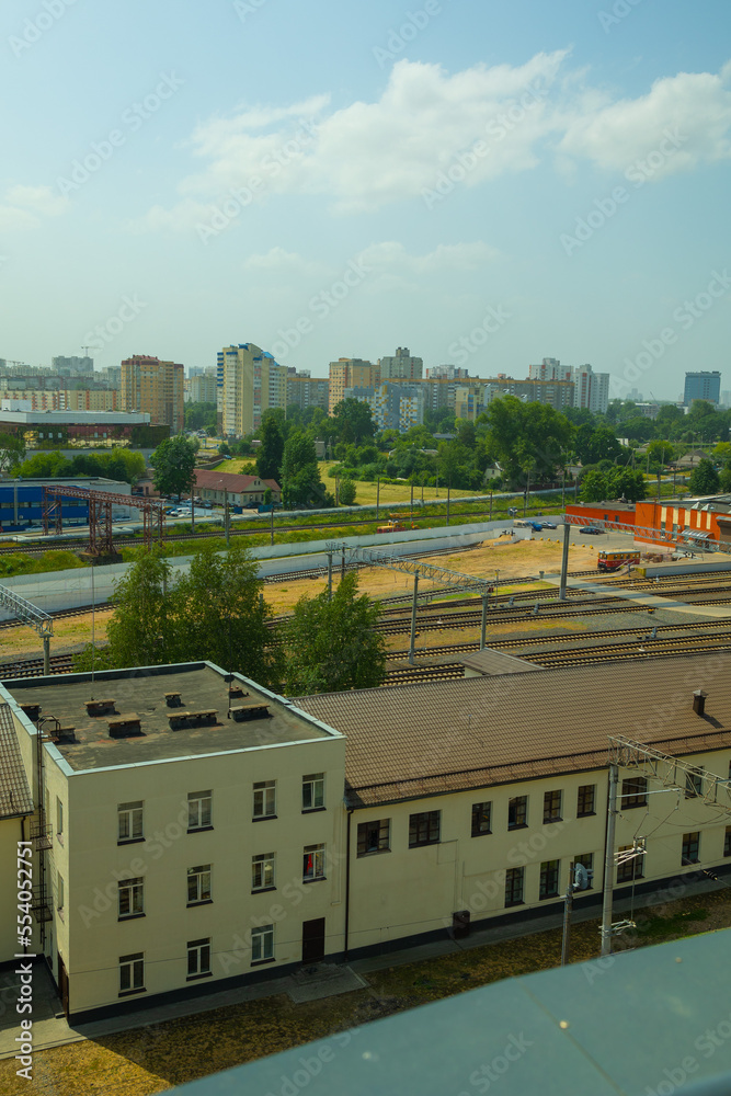 Railway tracks on a summer day and a view of the station