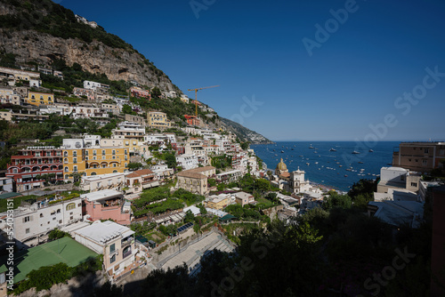Positano with hotels and houses on hills leading down to coast  comfortable beaches and azure sea on Amalfi Coast in Campania  Italy.