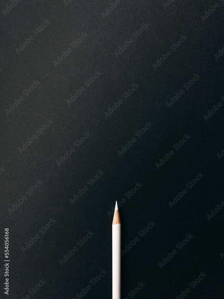 White sharp pencil isolated on a black background top viewed White sharp pencil isolated on a black background top viewed