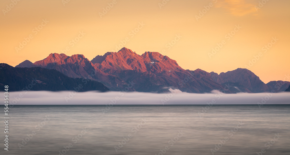 Kenai peninsula, Alaska; sunset over a fjord with low-hanging mist