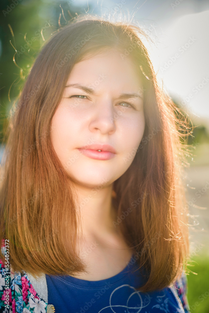 Portrait of a young beautiful long-haired girl on a summer day in sunny weather. Portrait of a young beautiful long-haired girl on a summer day in sunny weather.