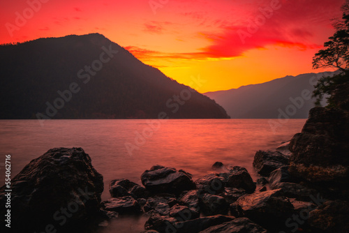 Olympic National Park Sunset Landscape Series, Pyramid Peak, Crescent Lake, glacial basalt rocks, and cumulus clouds at twilight near Port Angeles in Washington State, USA photo