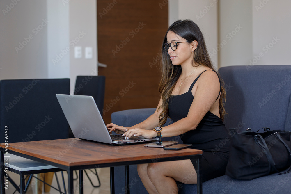 Portrait of a woman working on her laptop from her living room at home, with copy space Portrait of a woman working on her laptop from her living room at home, with copy space