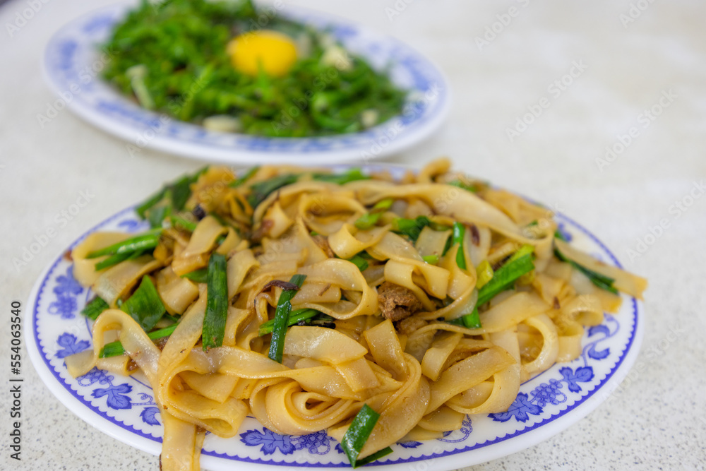 Taiwanese local food with fry vegetable and flat rice noodle