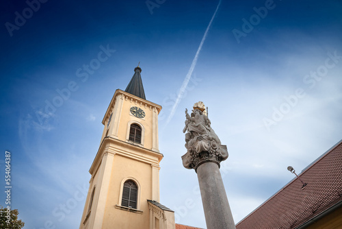 Church clocktower steeple of the serbian roman catholic church of crkva svetog karla boromejskog, also called church of saint carlo borromeo in Pancevo Voivodina, Serbia with its iconic clock.... photo