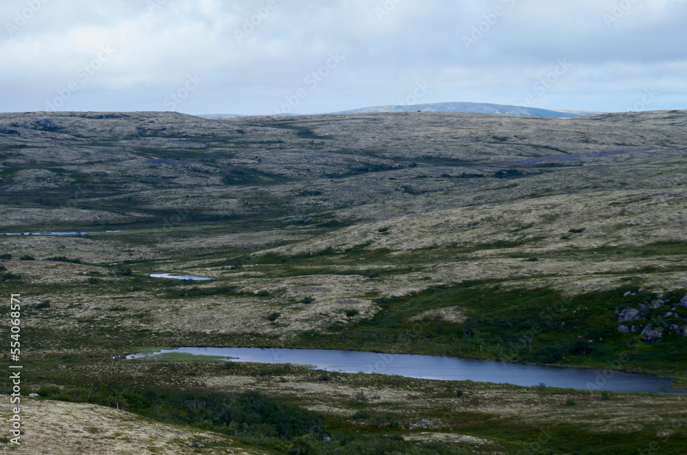 Summer landscape with hills and lakes on a cloudy day