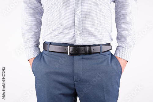 male model looks leather belt with hands in pocket