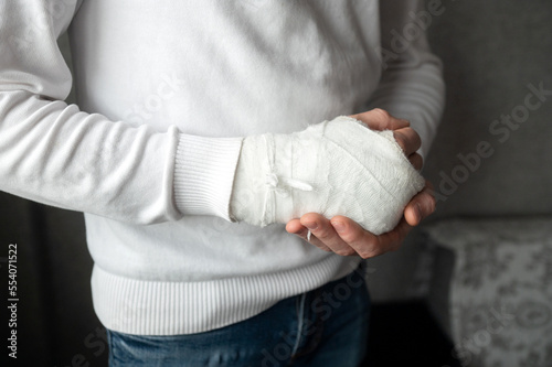 A man's broken arm in a cast