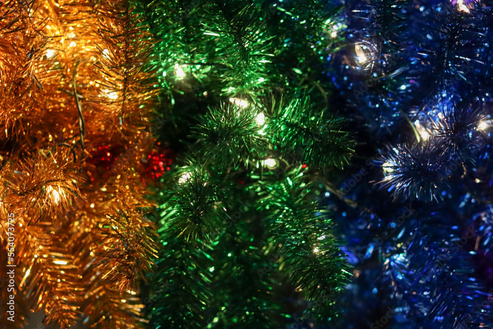 Blue, green and yellow Christmas garland with lights.