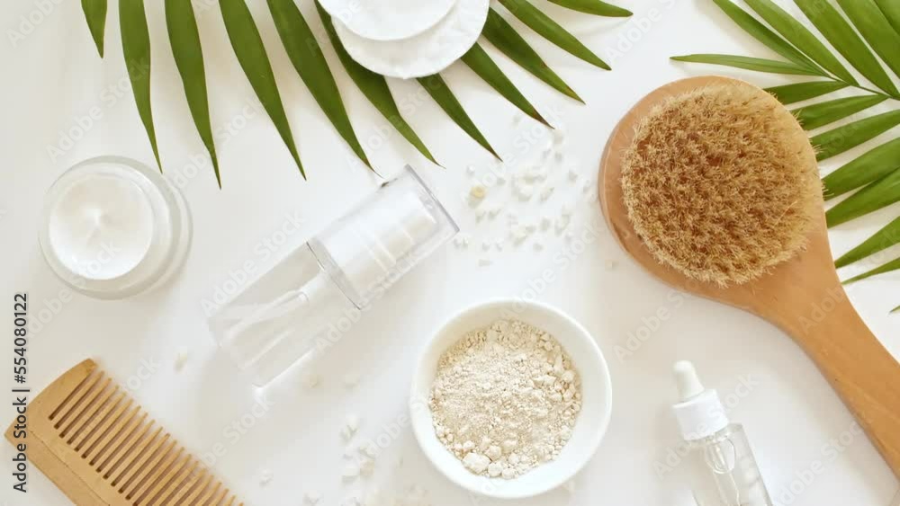 Eco friendly products on white background with green palm leaves. Gel, fluid, collagen serum, essential oil, salt, massage stone. Natural organic skin care eco-cosmetics. flat lay. 4k Eco friendly products on white background with green palm leaves. Gel, fluid, collagen serum, essential oil, salt, massage stone. Natural organic skin care eco-cosmetics. flat lay. 4k