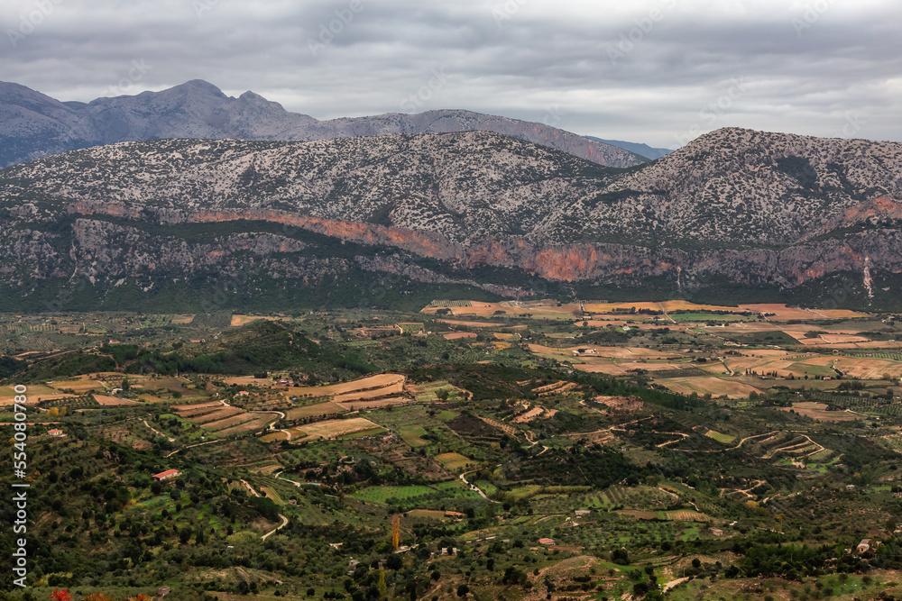 Fototapeta premium Farms and green fields with Mountain Landscape Background. Near Dorgali, Sardinia, Italy.