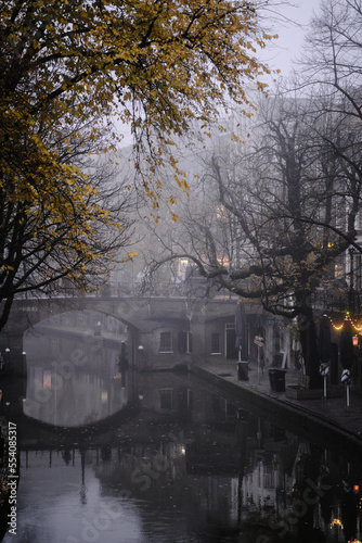 Utrecht, The Netherlands, November 29, 2022. Bridge over the Oudegracht canal in autumn fog.