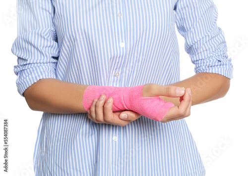 Young woman with hand wrapped in medical bandage on white background, closeup