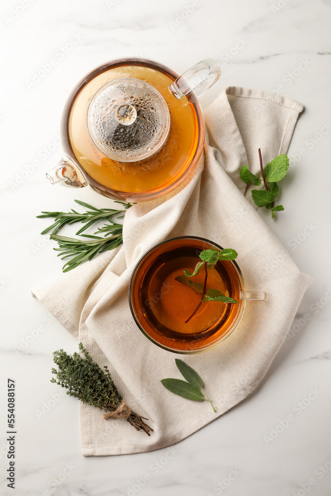 Aromatic herbal tea with rosemary, sage, thyme and mint on white marble table, flat lay - obrazy, fototapety, plakaty 