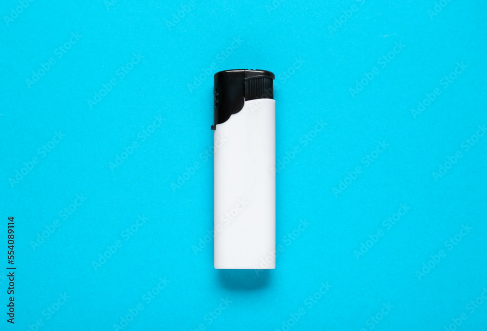 White plastic cigarette lighter on light blue background, top view White plastic cigarette lighter on light blue background, top view