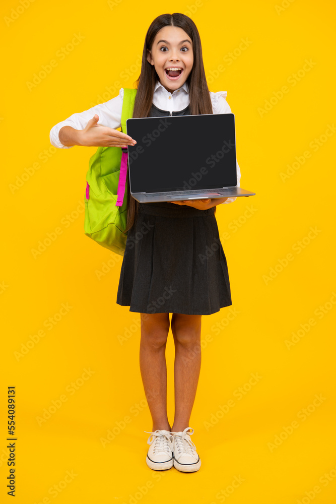 Young girl student, studying hold computer. E-learning concept. Funny pupil with laptop. Back to school. Excited face, cheerful emotions of teenager girl. Screen of laptop with copy space mock up. Young girl student, studying hold computer. E-learning concept. Funny pupil with laptop. Back to school. Excited face, cheerful emotions of teenager girl. Screen of laptop with copy space mock up.