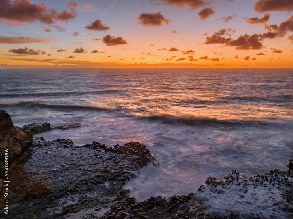 Surfs up sunrise at the seaside with scattered clouds Surfs up sunrise at the seaside with scattered clouds