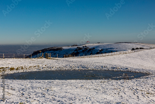 Snow on Ditchling Beacon in Sussex  with a Frozen Dew Pond in the Foreground