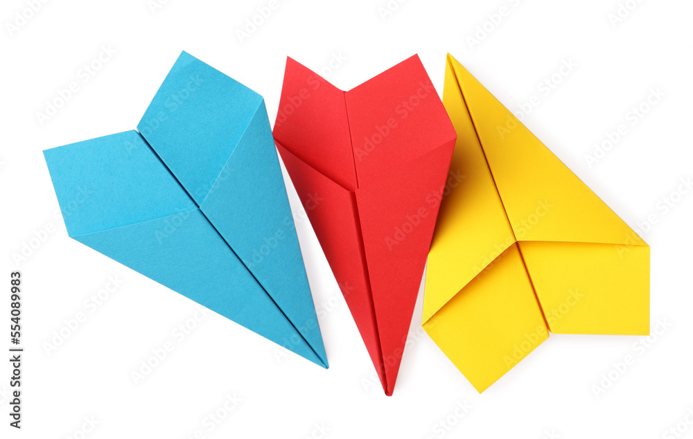 Handmade yellow, light blue and red paper planes isolated on white, top view Handmade yellow, light blue and red paper planes isolated on white, top view