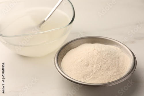 Agar-agar jelly and powder on white table, closeup