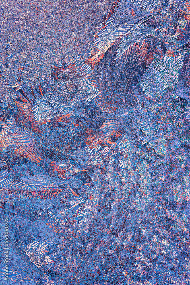 Winter Icy and Frosty Patterns on the Window Glass.  Background for Christmas and New Year. Macro Close Up