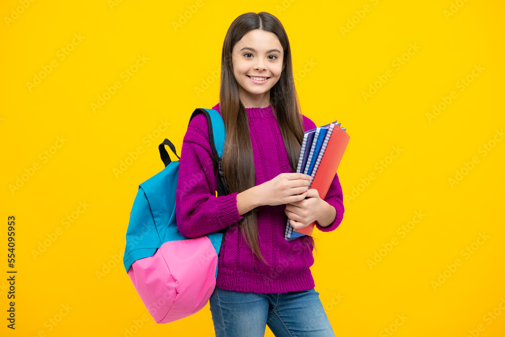 Schoolchild, teenage student girl hold book on yellow isolated studio background. School and education concept. Back to school. Schoolchild, teenage student girl hold book on yellow isolated studio background. School and education concept. Back to school.