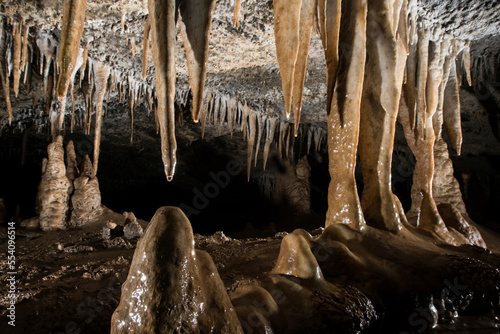 Tiny drops of water clings to the bottom of a stalactite in Whiterock Cave.; Gunung Mulu National Park, Sarawak, Borneo, Malaysia.