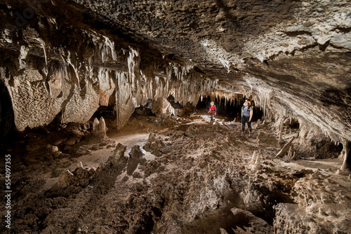 Researchers exploring stalagmites in a cave in Gunung Mulu National Park; Sarawak, Borneo, Malaysia photo