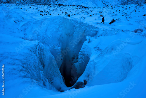 A cave explorer at a giant moulin, named None Stop, on the Gorner Glacier in Switzerland.