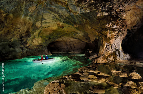 Vászonkép Explorers paddle on a lake inside Krizna jama, the Cross Cave.