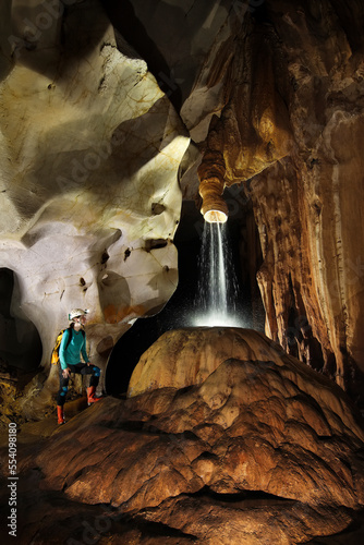 A Mulu Cave Project expedition member admires a rare calcite crystal formation.