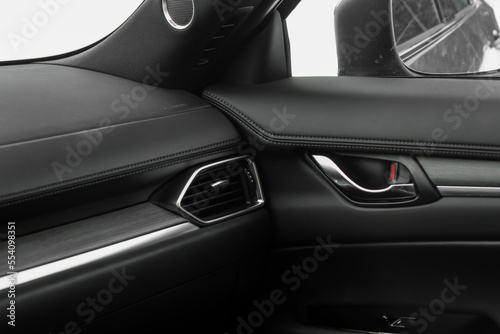 Modern car interior details. Car wooden panel. Interior of prestige modern car. © Roman