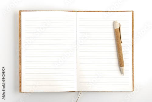 Opened notebook with pen on white background