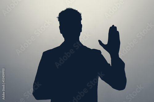 Unknown male silhouette making a promise or oath. I will tell only the truth photo