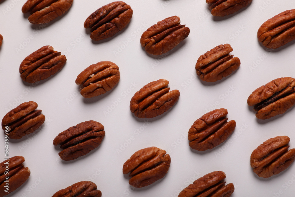 Delicious fresh pecan nuts on white background, flat lay Delicious fresh pecan nuts on white background, flat lay