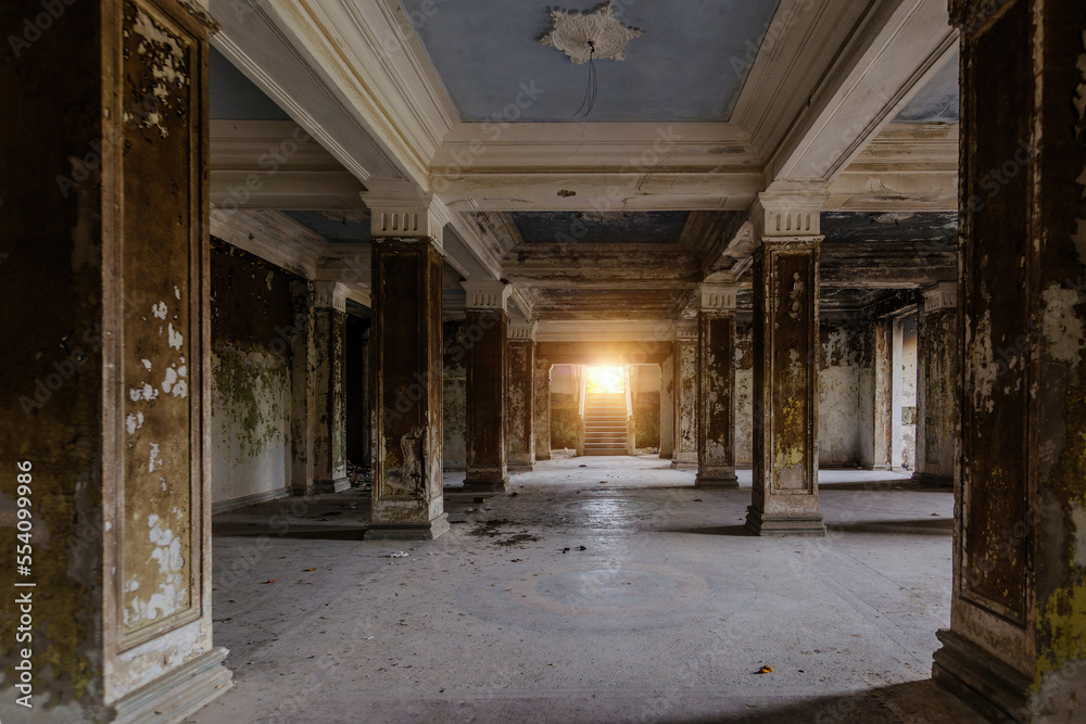 Large hall with columns in old abandoned mansion