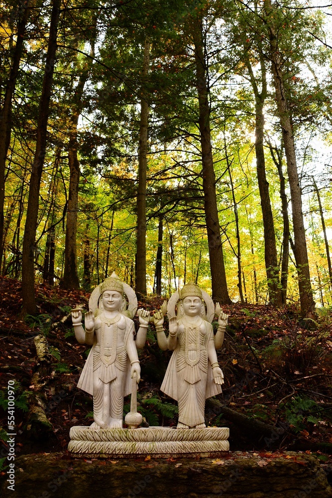 Fototapeta premium VISHNU AND LAKSHMI, stone sculpture in Humanics Sanctuary & Sculpture Park, fall in Ottawa, Canada