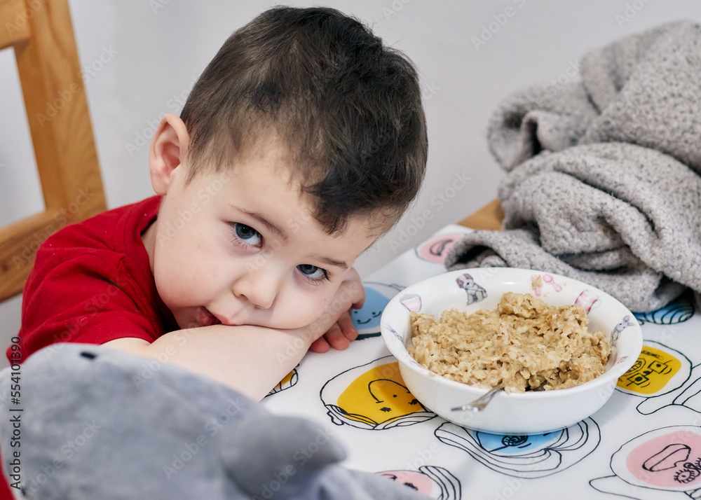cute young boy being patient while waiting for his food to cool down cute young boy being patient while waiting for his food to cool down