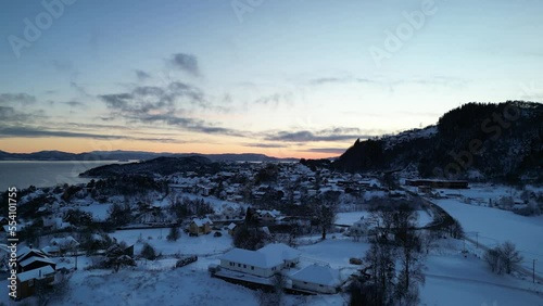 Sunset over Norwegian coastal landscape. Winter, mountains and fjord.