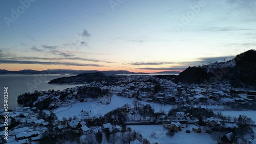 Sunset over Norwegian coastal landscape. Winter, mountains and fjord.