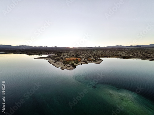 wide angle view from aerial view drone shot of lake mohave in the national recreation area of lake mead in nevada and arizona with the sun setting showing six mile cove and its sand photo